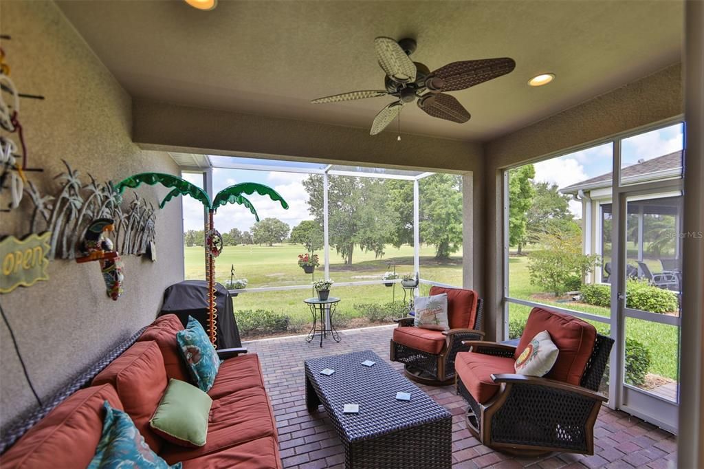 This large, screened, extended pavered lanai looks out over the greenbelt with no neighbors in the backyard.