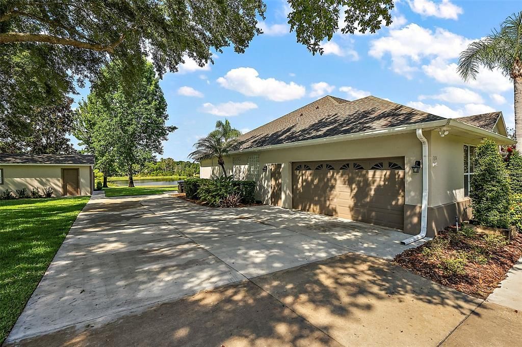 Side-entry 2-car garage and 2024 concrete block workshop. Note Lake Angelina!