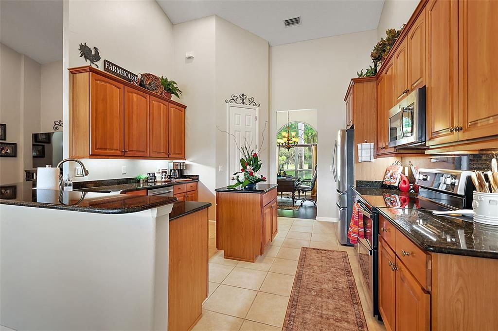 Wood cabinetry, Granite countertops, prep island, walk in pantry. Beautiful!
