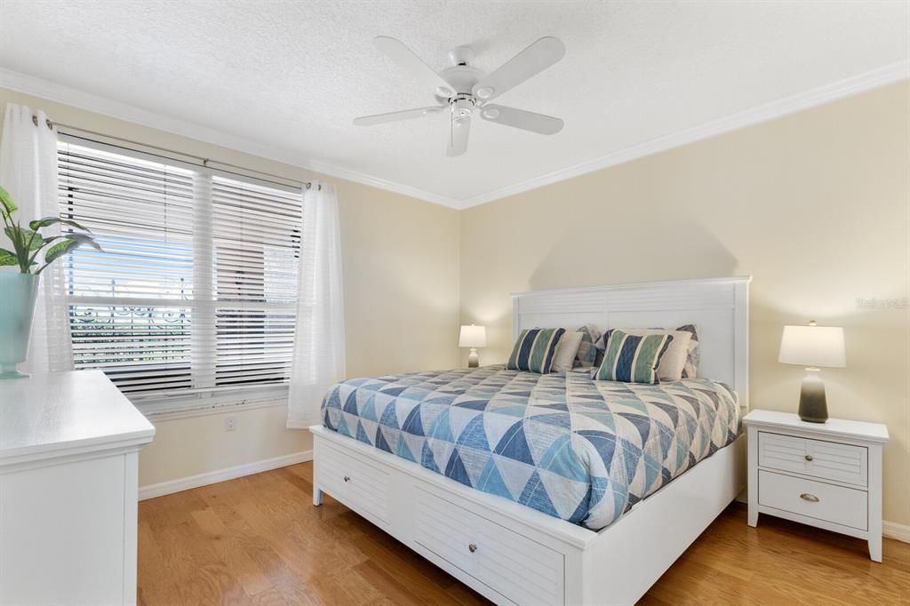 Guest bedroom with wood floors