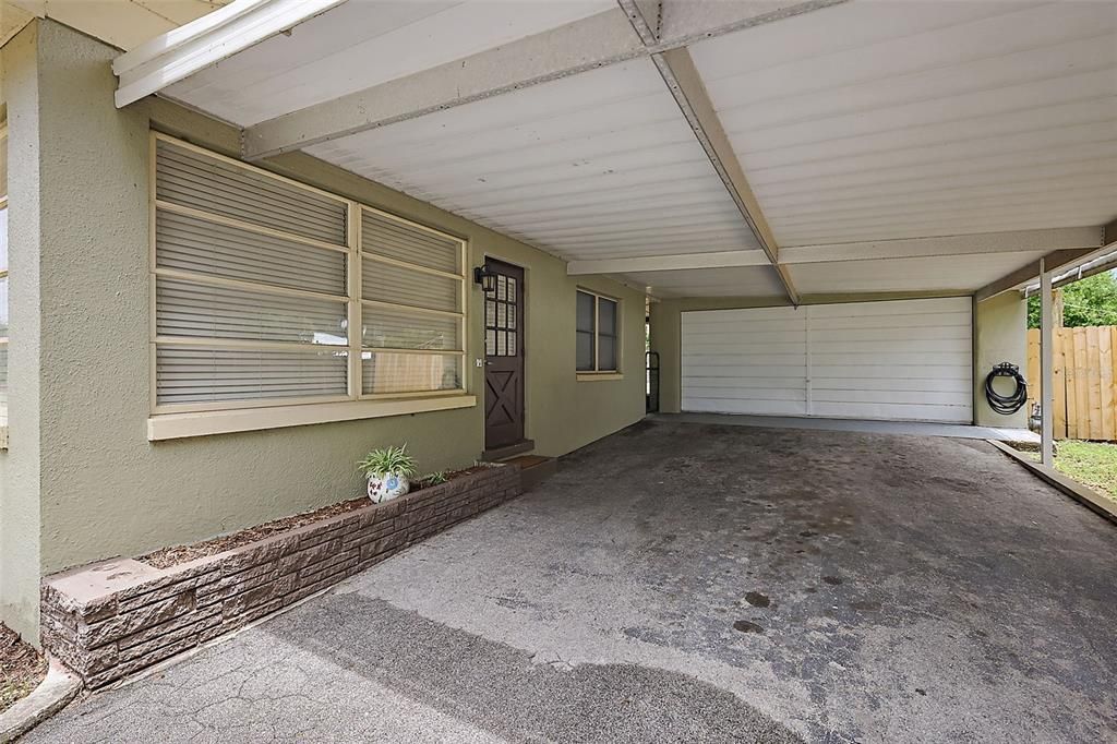 Carport then leads to the 2 car garage