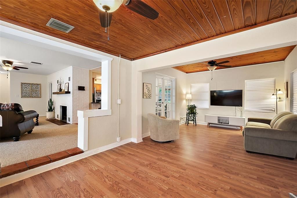 Den/office has laminate floors, cedar wood ceilings and fans