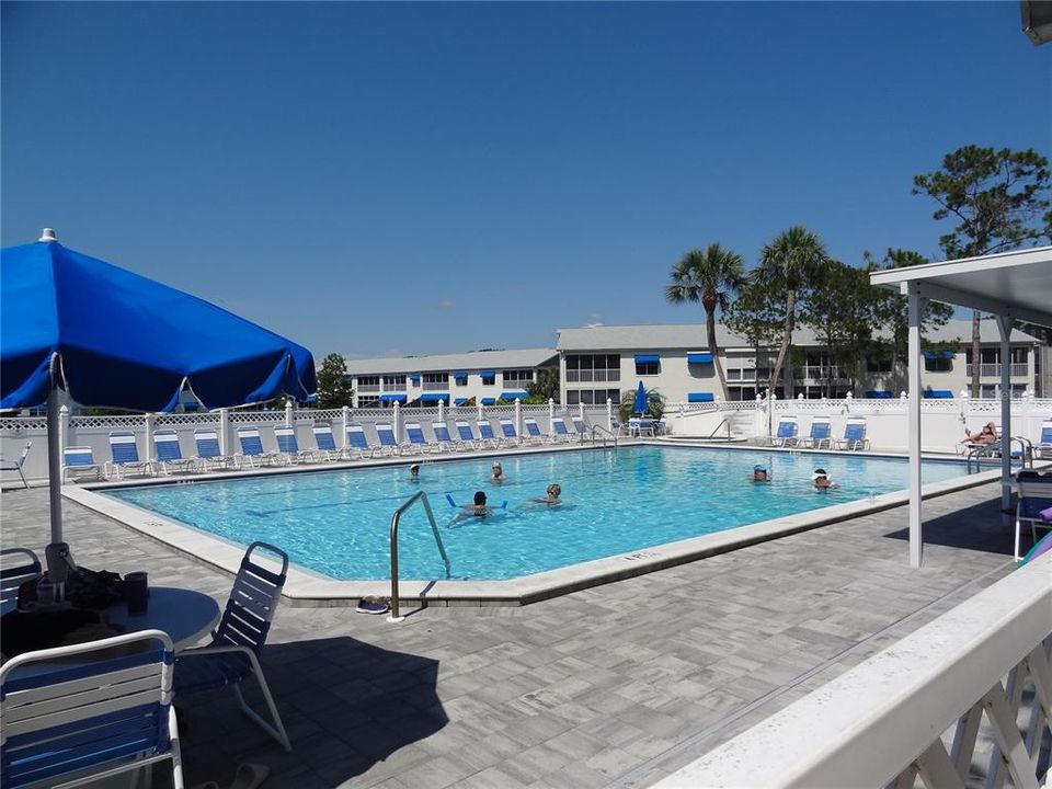 Heated pool by fitness room and small clubhouse