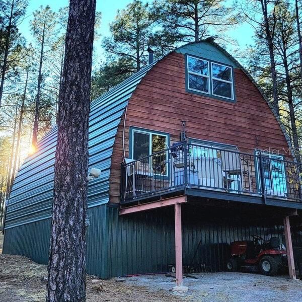 Stock photo of 24' X 32' Arched Cabin.*Example only, steel frame cabin kit conveying with lot is un-assembled.