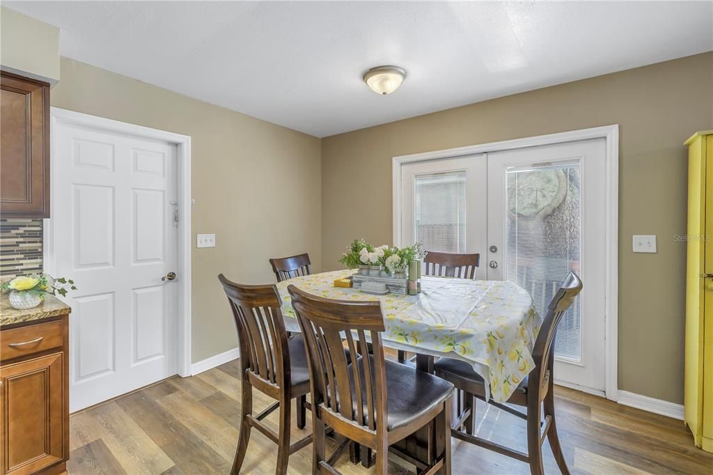 Kitchen/dining, French doors to side deck and door that leads to back family room down a few steps.