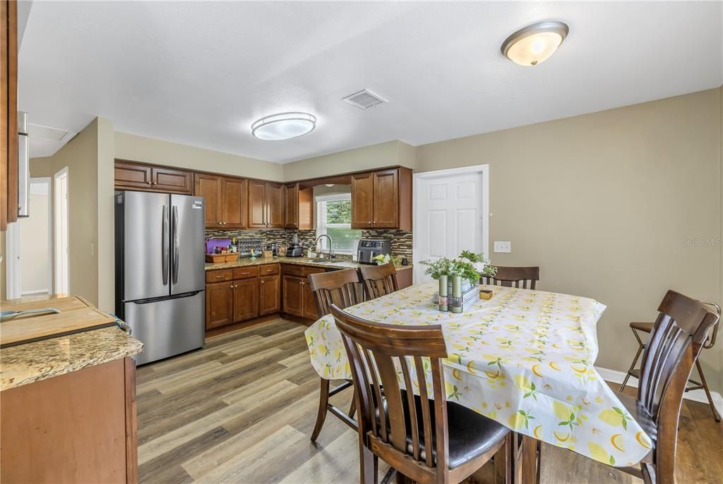 Kitchen/dining with stainless appliances and a brand new fridge.