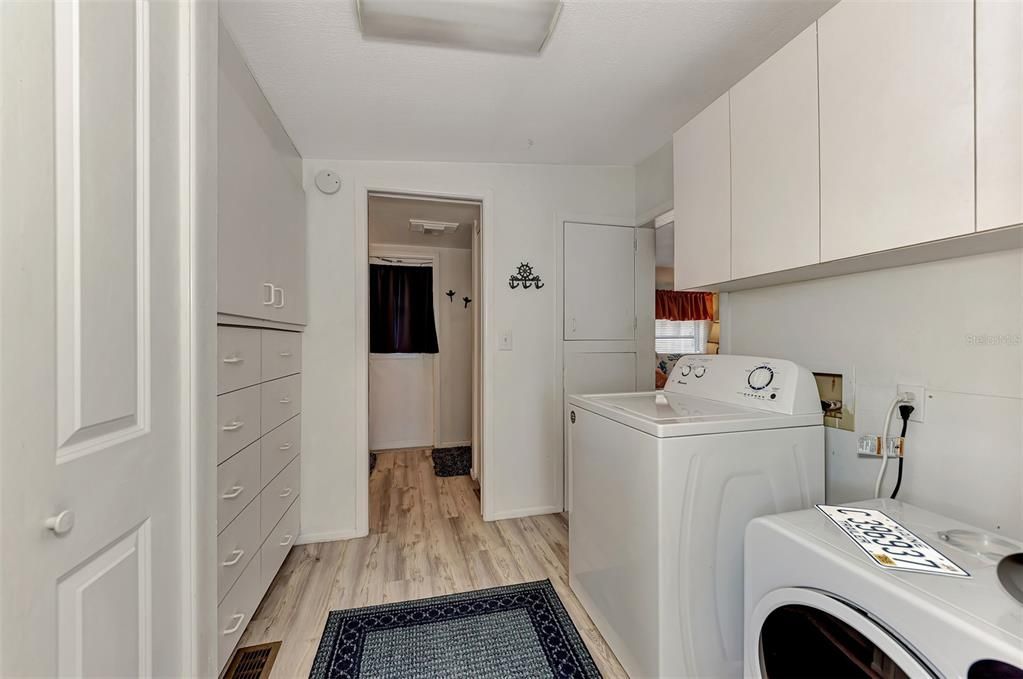 Washer and Dryer in the hallway the leads to the back master bedroom