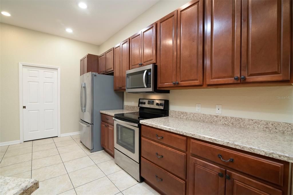 The doorway to the inside laundry room is in the background of this kitchen view.