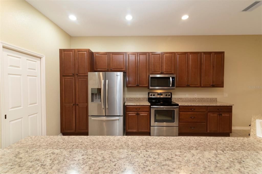 The kitchen has birch cabinets with 42" uppers and pulls.