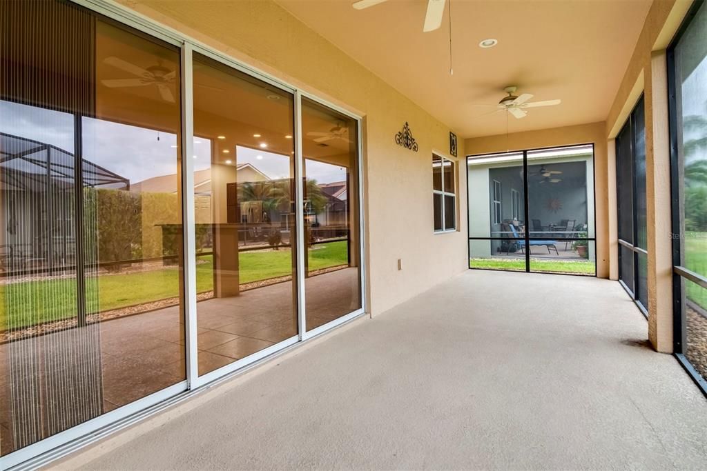 The covered and screened lanai is accessed by the living room's triple 8' sliders.