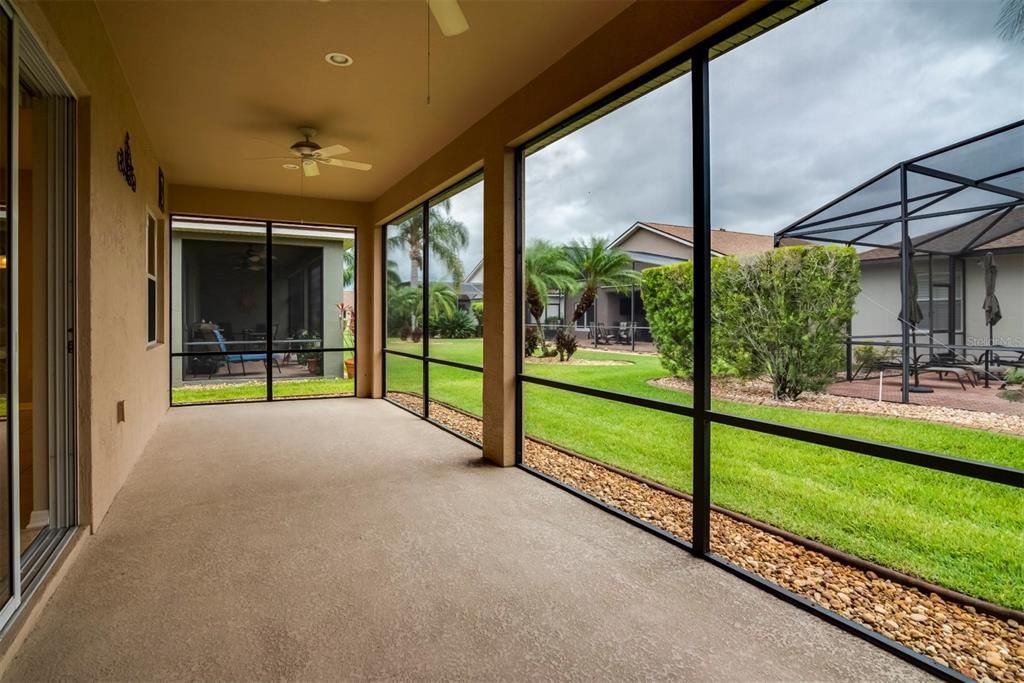 The covered and screened lanai has 2 ceiling fans and a "Flo-Crete" floor.