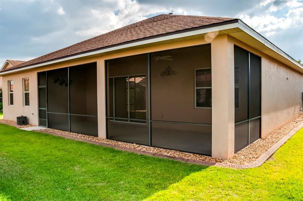 The huge covered and screened lanai dominates the rear of this home.