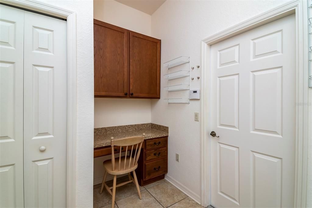 The laundry room has an extra deep closet/pantry and a built-in desk area.