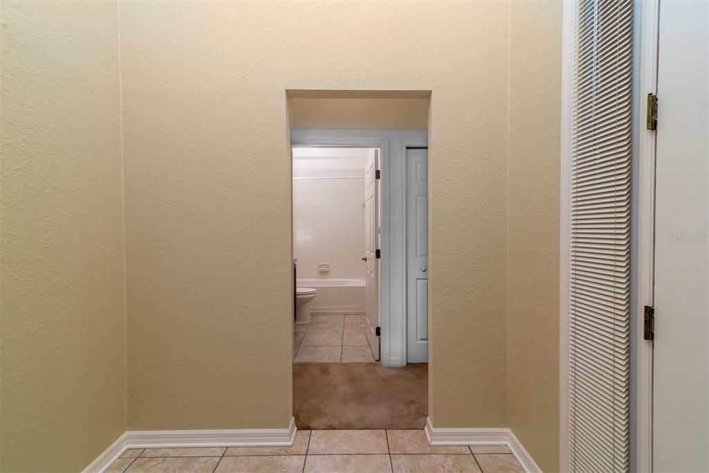 This passageway leads to the 2 guest bedrooms and guest bathroom. The guest linen closet is partially seen next to the guest bathroom doorway.