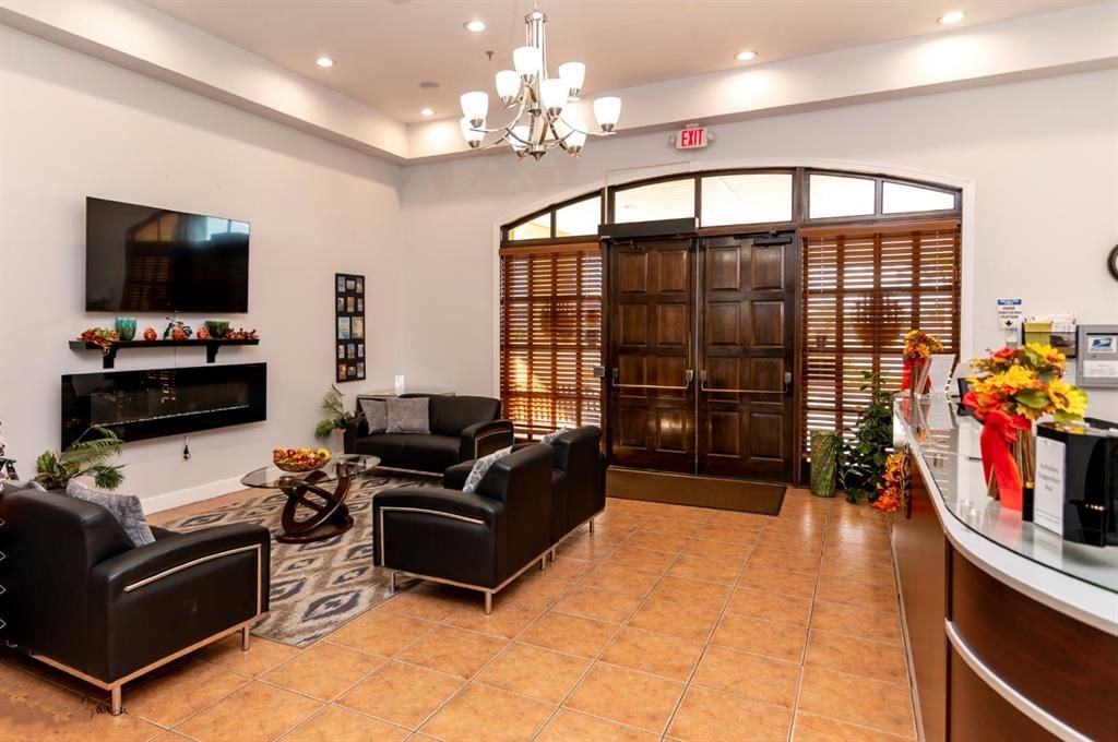 The foyer to the Health and Fitness Center has a seating area and the activities desk.