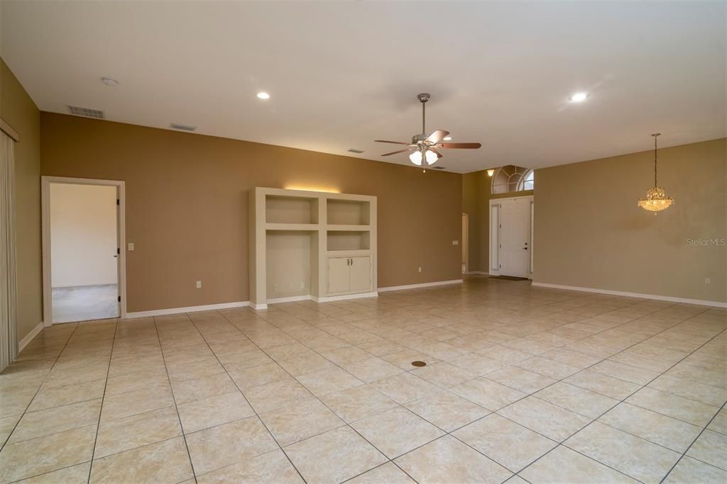 This view of the living room to the south shows the doorways to the master suite and the guest wing that is just off the foyer. The built in entertainment center awaits your components.