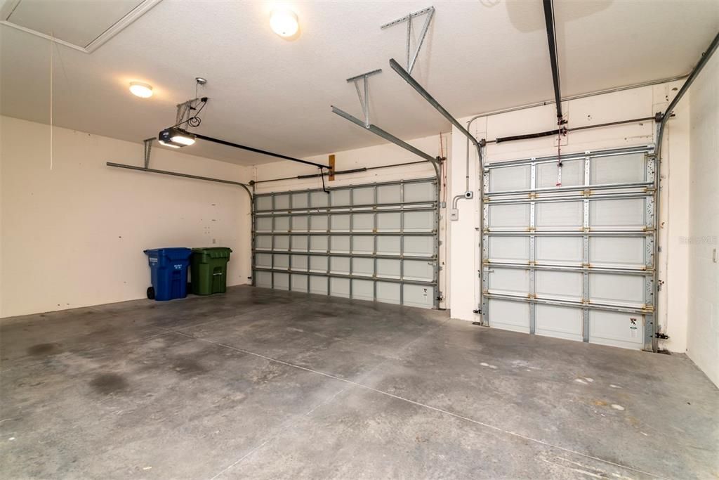 The attached 2 car and golf cart garage has lots of space. The 220 outlet for EV storage is between the doors.