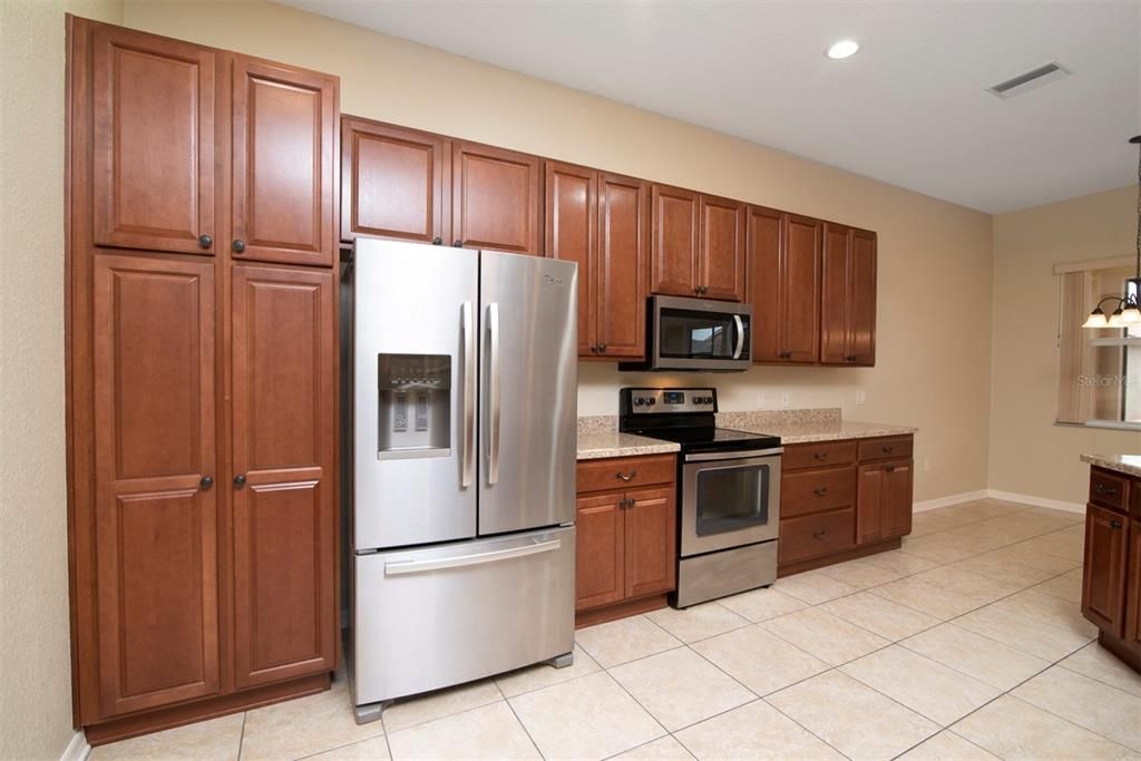 The ample amount of cabinets and counters includes a bank of drawers.