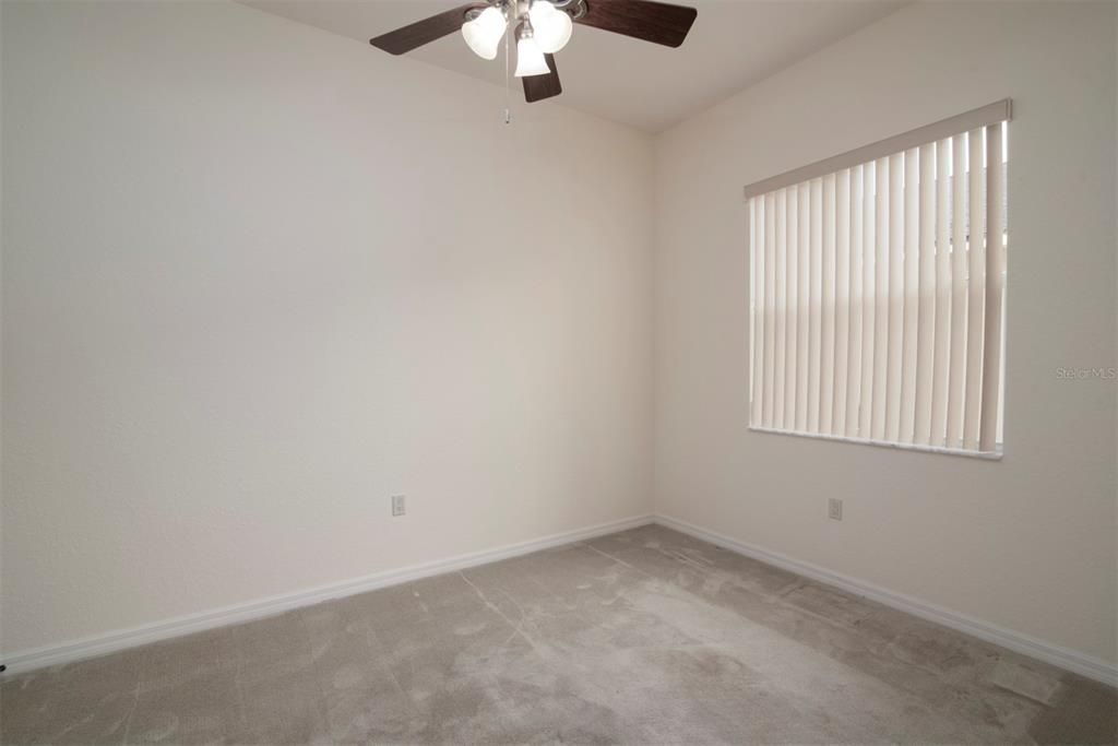 The second bedroom has upgraded carpeting and ceiling fan with light.