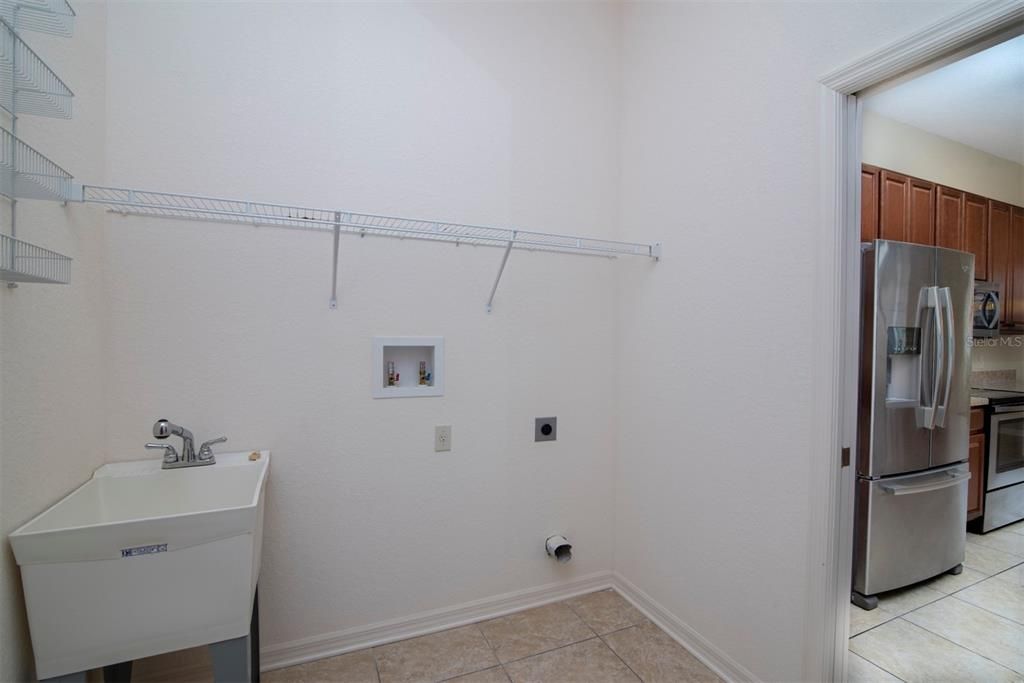 The inside laundry room doubles as the mud room for the attached garage. The handy utility sink is a plus.