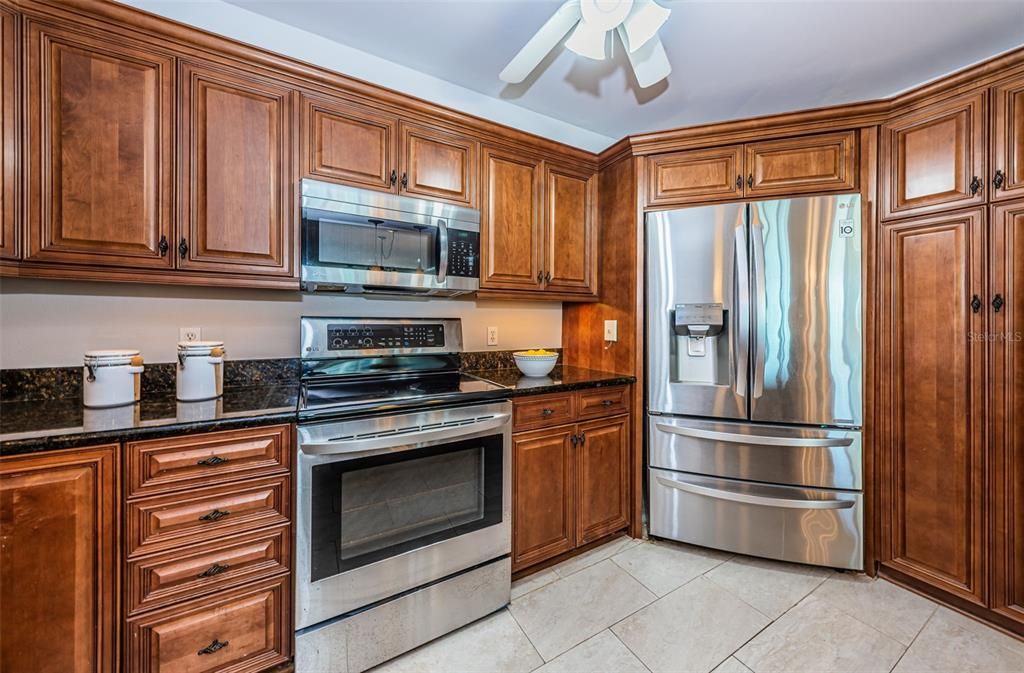 Open Cucina Accessorized with Stainless Appliances, Granite Surfaces and More!