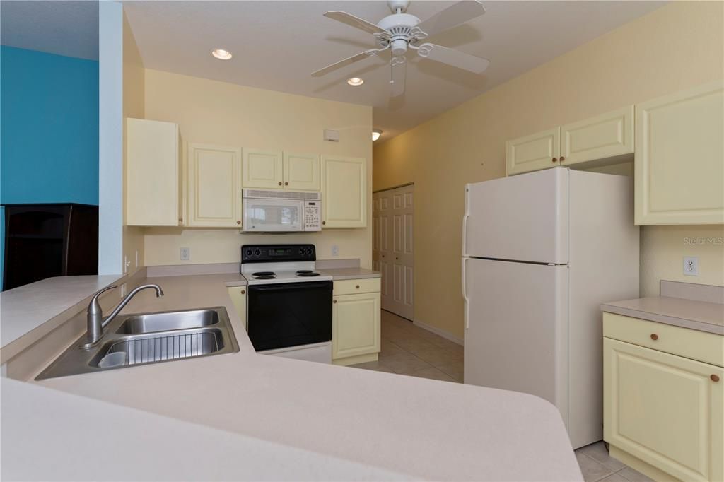 breakfast bar, wall pantry closet in hallway to garage