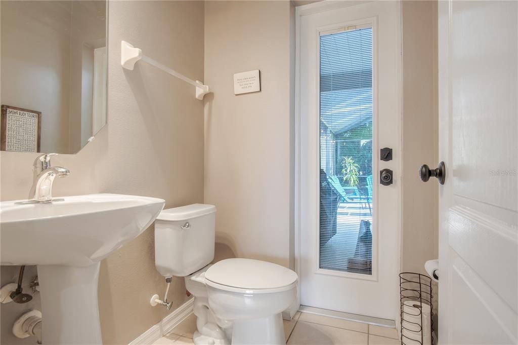 Half bath downstairs leading to pool