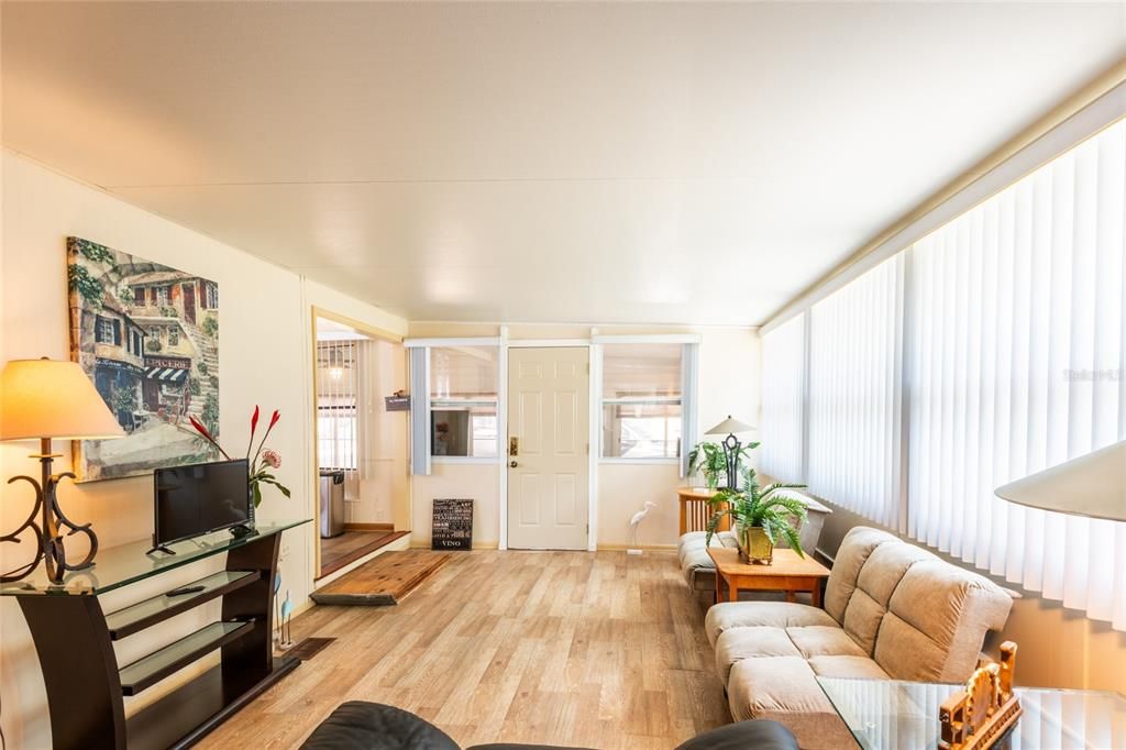 Kitchen on the left, door leads to the Sunroom.