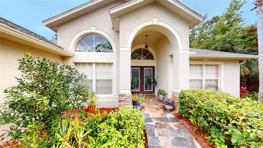 Front of property with tiles walkway