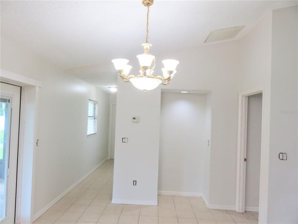 Hallway to Garage, Dining area, door to primary bedroom