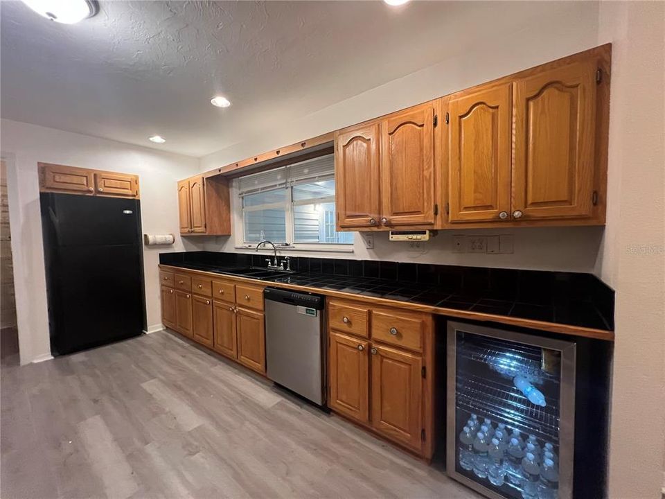 Refrigerator and water cooler space with storage and cabinetry