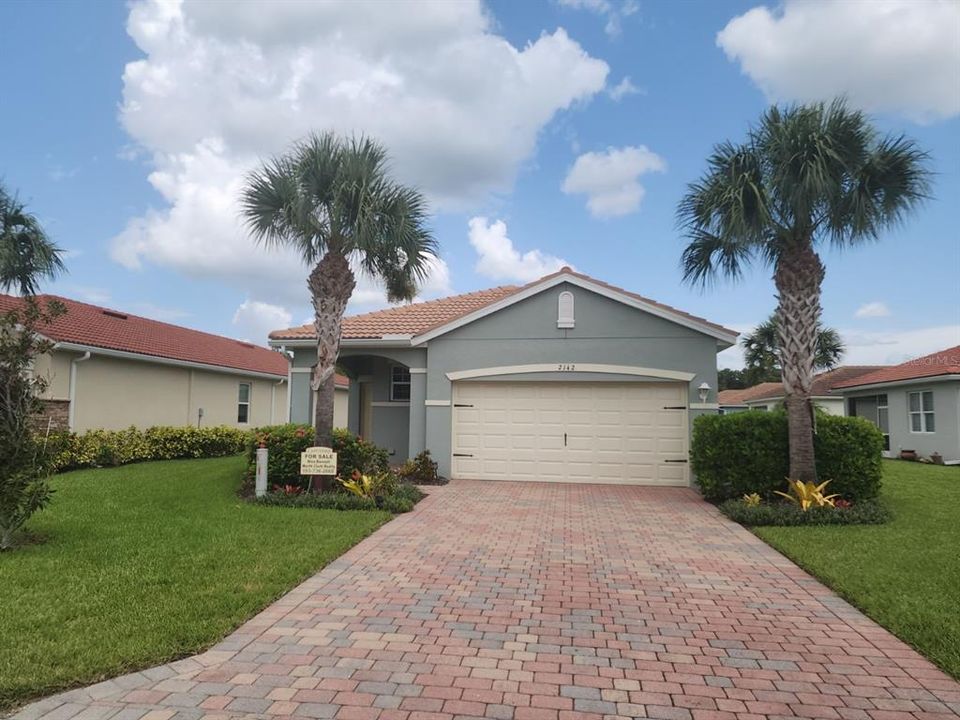 Front of house featuring long paved driveway