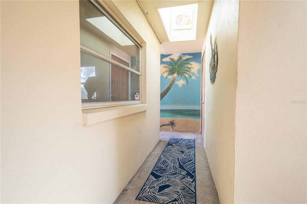 A breezeway with a tropical mural leads to the 3rd bedroom/in-law suite.