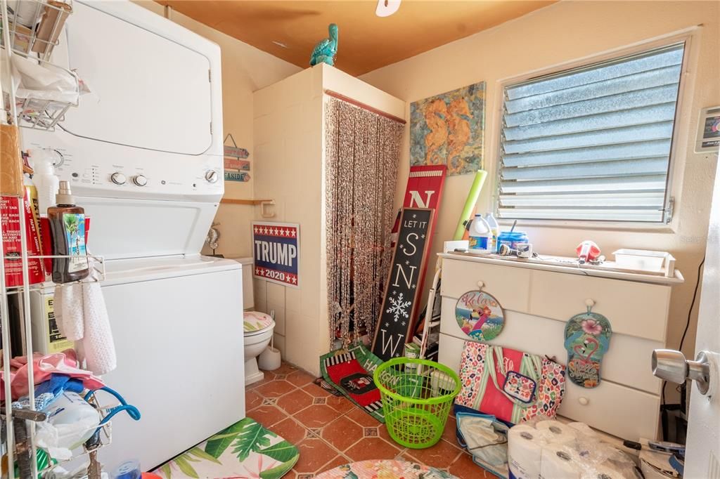 The breezeway also leads to the laundry room and half bath with tile floor. Included is a stackable washer/dryer