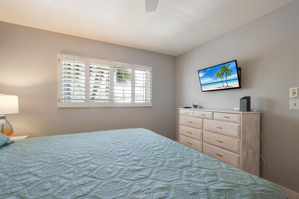 second bedroom with plantation shutters and impact windows