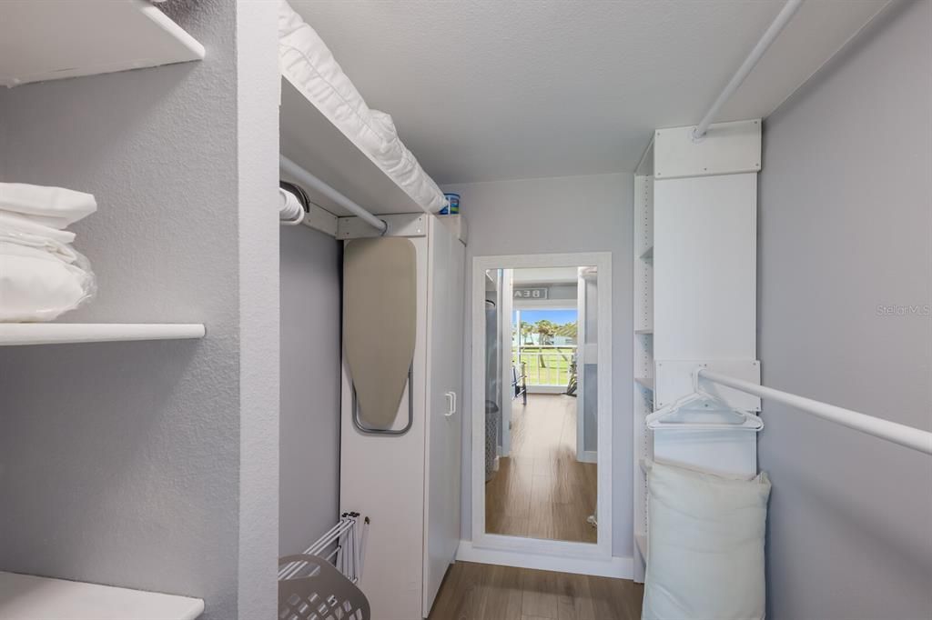 Large walk-in closet in the primary suite with built ins