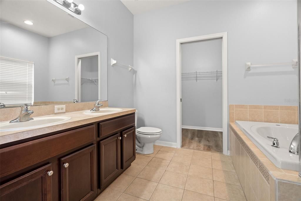 The master en suite has a double sink, marquis light fixture, walk-in closet, soaking tub and separate shower.