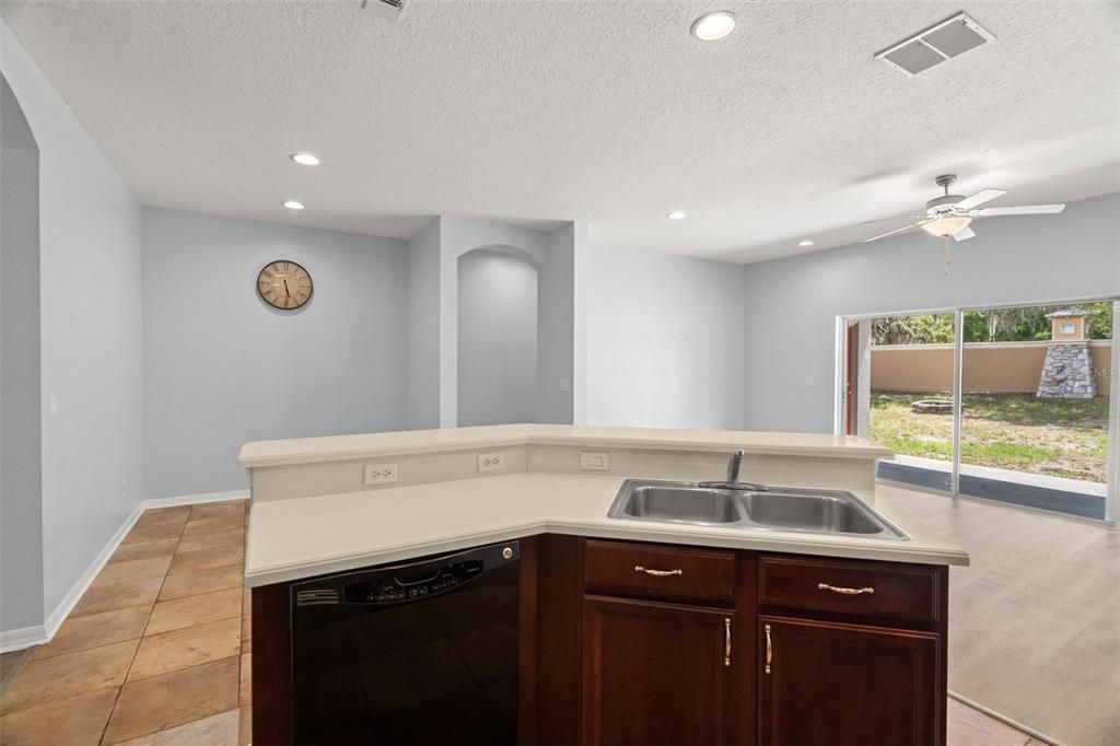 View from kitchen range towards dining space and island.