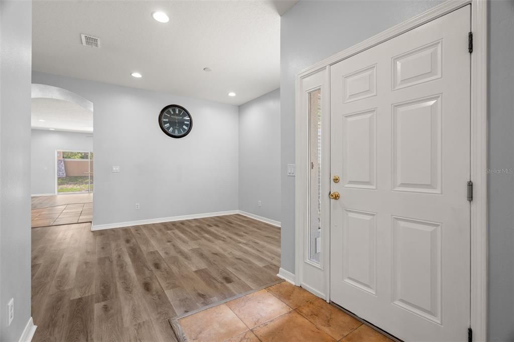 Front entry with den/home office space to the left and to the right additional dining with a nice deep coat closet, recessed lighting and multiple windows.