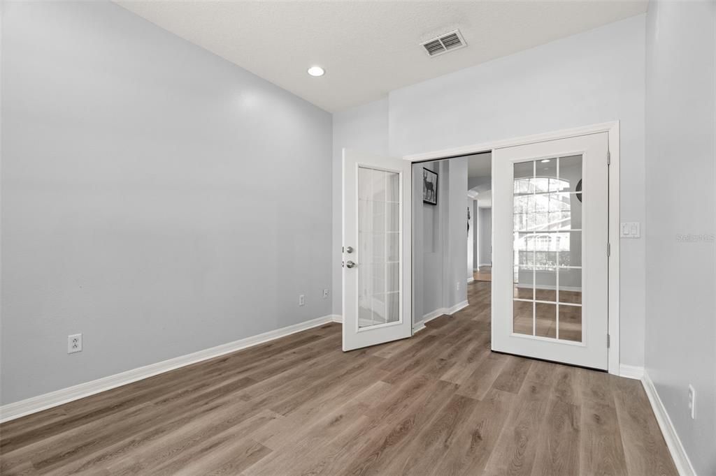 View towards front entry area from corner of home office/den.