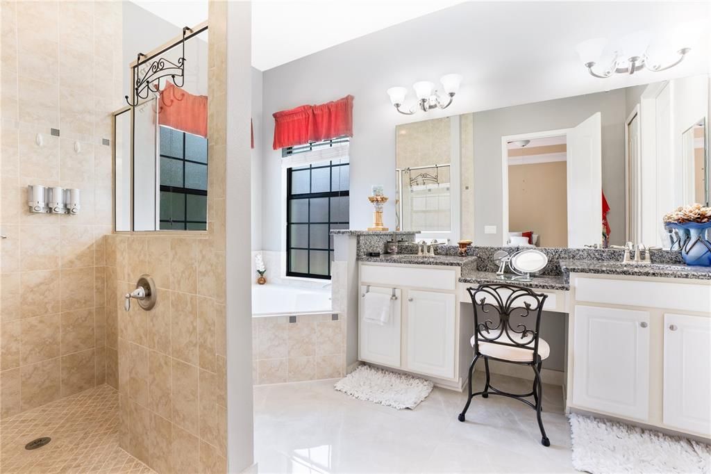 Primary bathroom with walk in shower and garden tub.