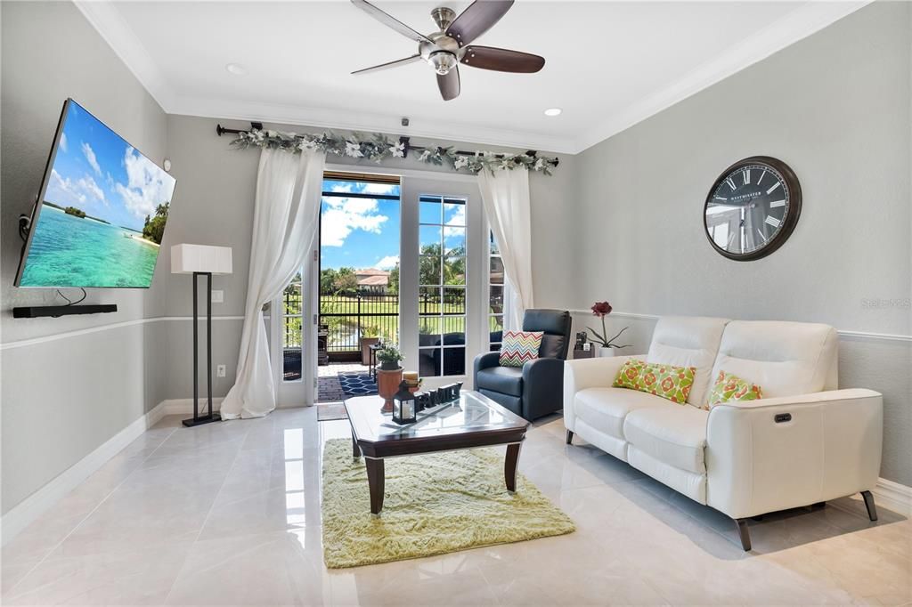 Family room with french doors leading to screened in Lanai