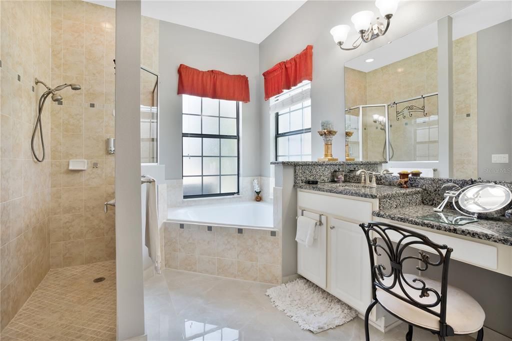 Primary bathroom with double sink and vanity seating