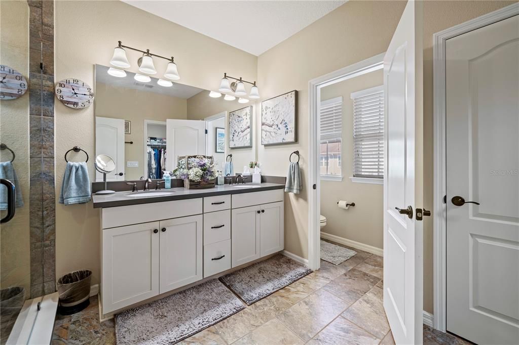 Primary Ensuite bath with double vanities and water closet