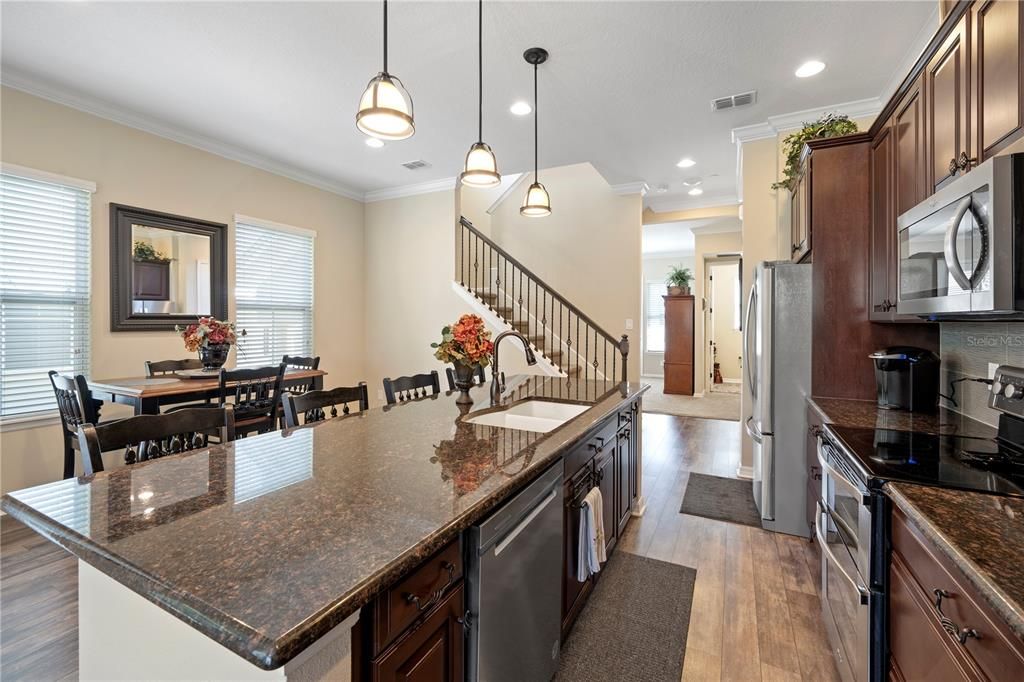 Open floor plan makes meal prep and entertaining a breeze. Complete with designer Timberlake cabinetry with 42" upper cabinets, granite countertops and stainless steel appliances this kitchen is a dream come true.