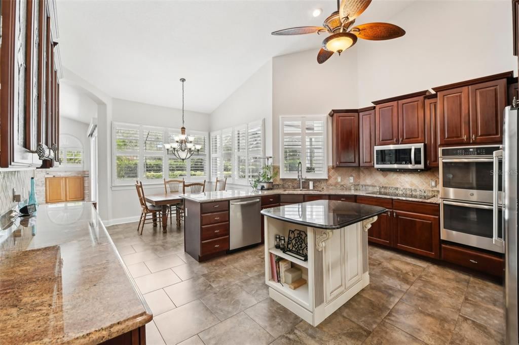 Gourmet kitchen with cafe style dining providing beautiful views of the back yard