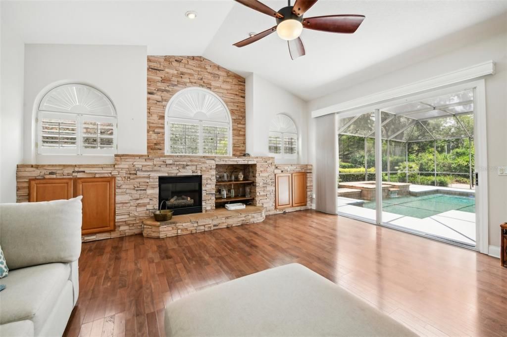 Family room at the back of the home with sliding doors featuring remote controlled blinds