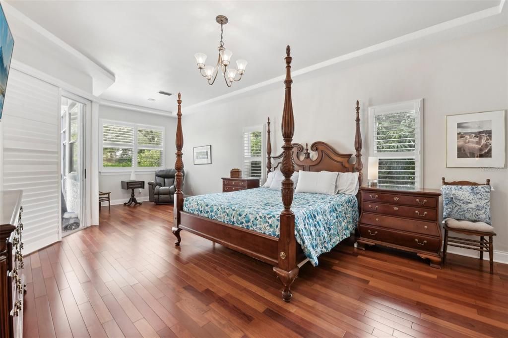 Primary bedroom features a sitting area with views of the backyard