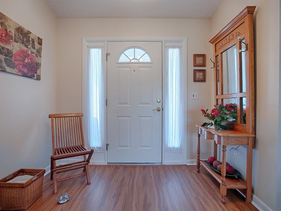 LIGHT AND BRIGHT FOYER... NOTE THE BEAUTIFUL VINYL PLANK FLOORING!