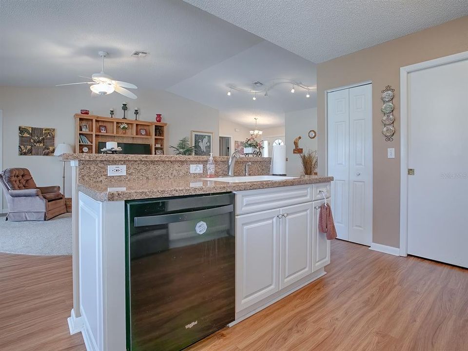 LOOK OUT FROM THE KITCHEN ISLAND AND BREAKFAST BAR INTO THE HEART OF THE HOME...